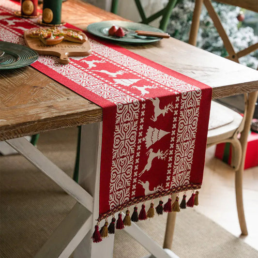 Red table runner with white patterns on a wooden table